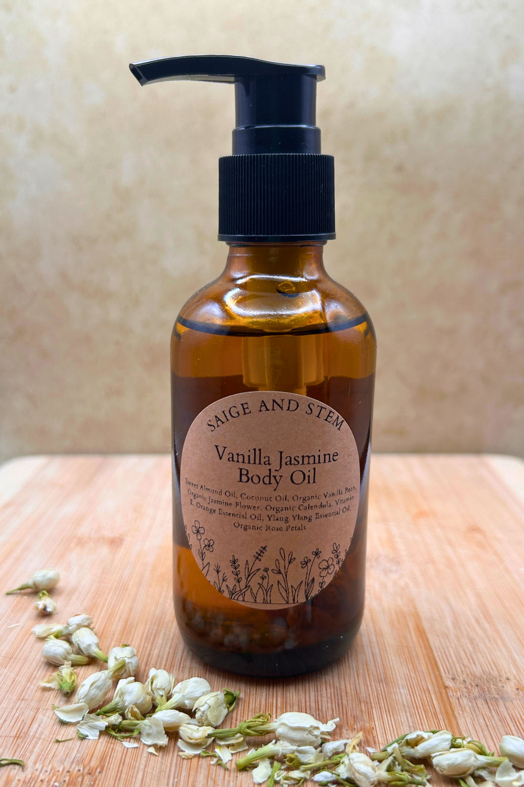 Vanilla Jasmine Body Oil in amber bottle with pump, featuring calendula flowers and jasmine notes.