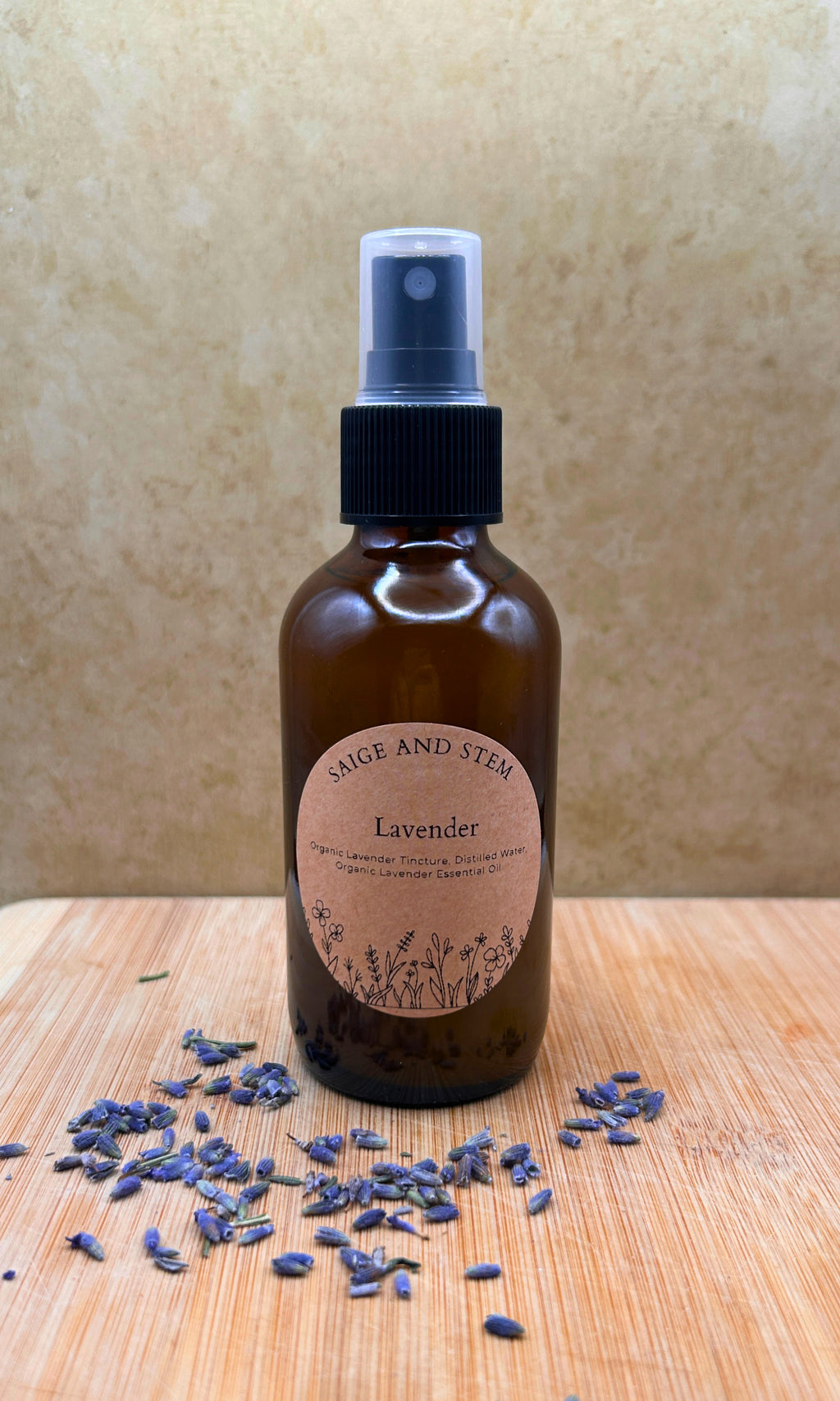 Lavender Ritual Mist in a brown glass bottle with a label, surrounded by dried lavender flowers.