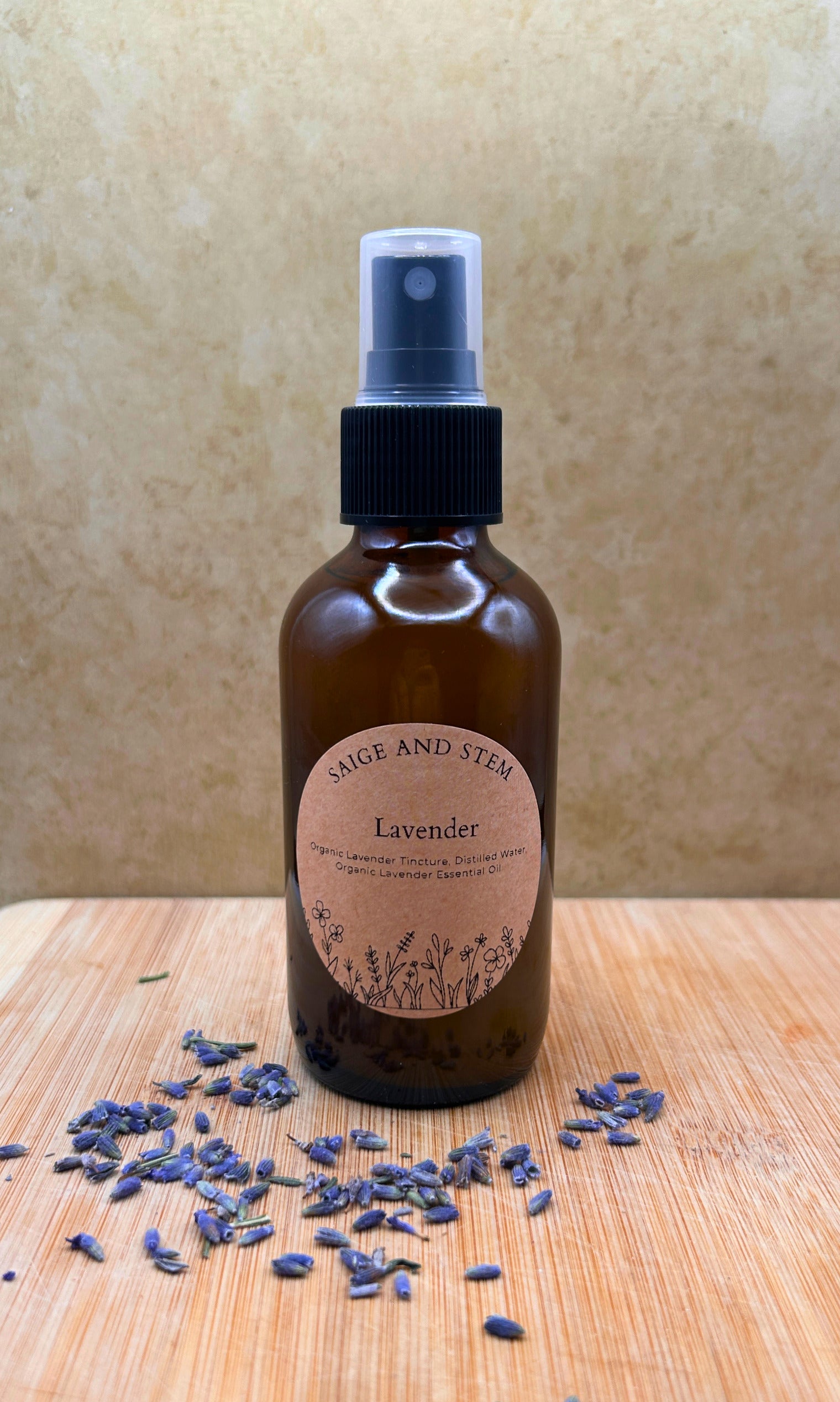 Lavender Ritual Mist in a brown glass bottle with a label, surrounded by dried lavender flowers.