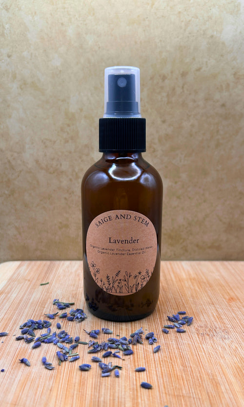 Lavender Ritual Mist in a brown glass bottle with a label, surrounded by dried lavender flowers.